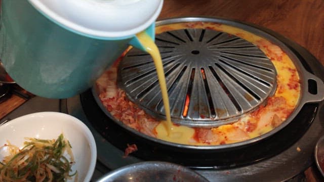 Meat Grilled on a Grill with Kimchi Egg Rolls