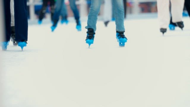 People ice skating at a rink