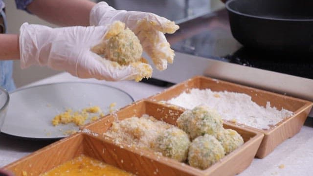 Batter of croquette made with chives batter in hot oil