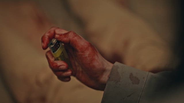 Bloody Hand Holding a Lighter