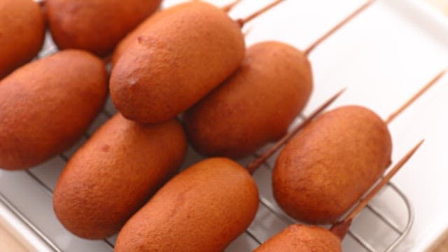 Hot dogs cooling on a rack after frying
