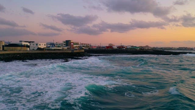 Coastal Village at Twilight with Waves Crashing