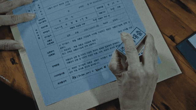 Person Stamping Seal on Documents about Loan