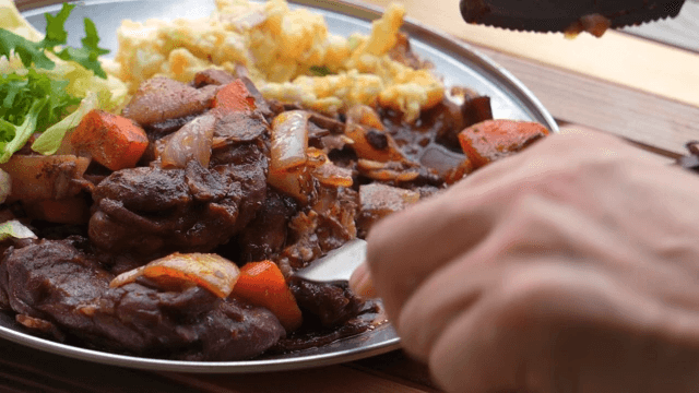 Dining scene of enjoying a delicious meat and vegetable stir-fry on a plate
