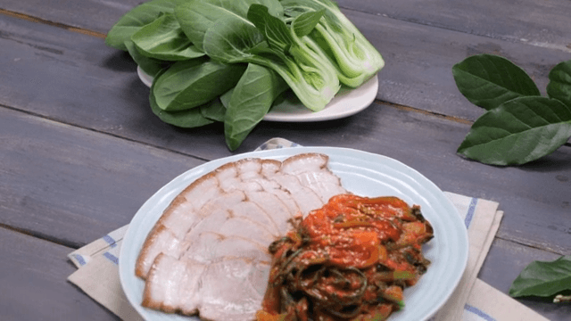 Plate of Korean boiled pork with bok choy kimchi