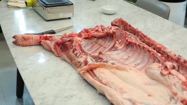 Large piece of pork on a kitchen table