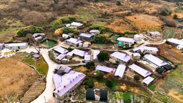 Rural village surrounded by fields and hills