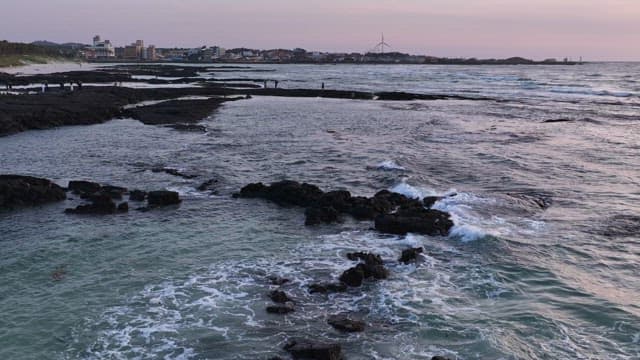 Rocky coastline at sunset with waves
