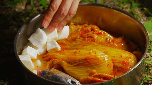 Kimchi stew with tofu and fish in a pot