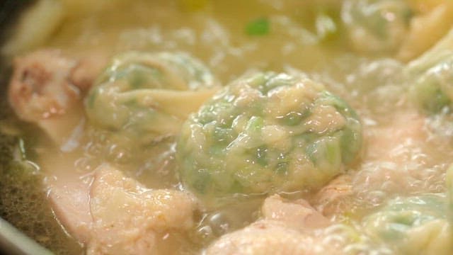 Dumplings boiling in a chicken soup