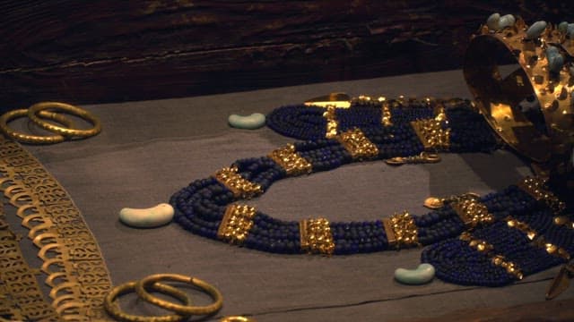 Ancient golden jewelry displayed under dim light