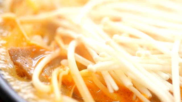 Ramyeon boiling with enoki mushrooms