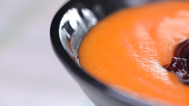 Bowl of carrot porridge with red beans