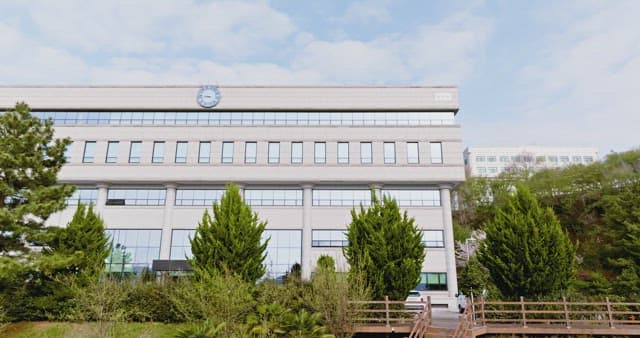 Campus building surrounded by trees