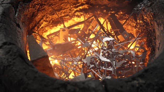 Metal pieces melting in a fiery furnace