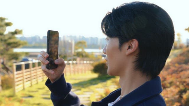 Man taking photos in a park
