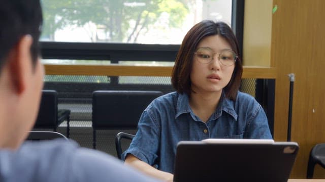 Woman wearing glasses having a meeting indoors
