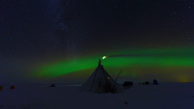 Aurora Borealis Over a Snowy Encampment