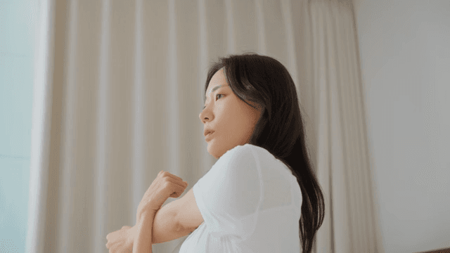 Woman Stretching and Relieving Stress Indoors