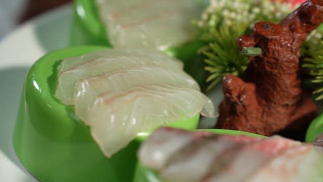 Enjoying Fresh Sashimi with Soy and Chili Sauce