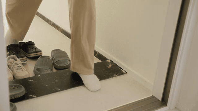Changing slippers at the apartment entrance