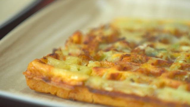 Delicious golden brown waffle on a plate