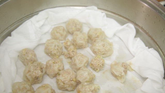 Steamed dumplings being prepared in a pot