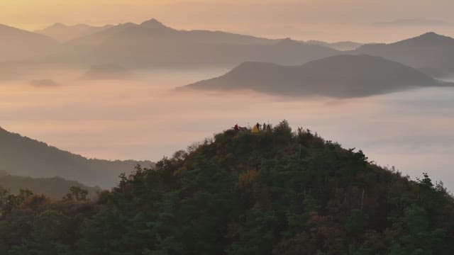Sky Colored by Sunrise over Foggy Mountains
