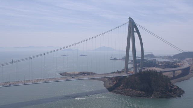 Magnificent Gogunsandaegyo Bridge over the sea with ship passing by