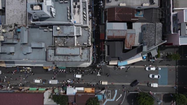 Street Crowded with People Between Buildings 