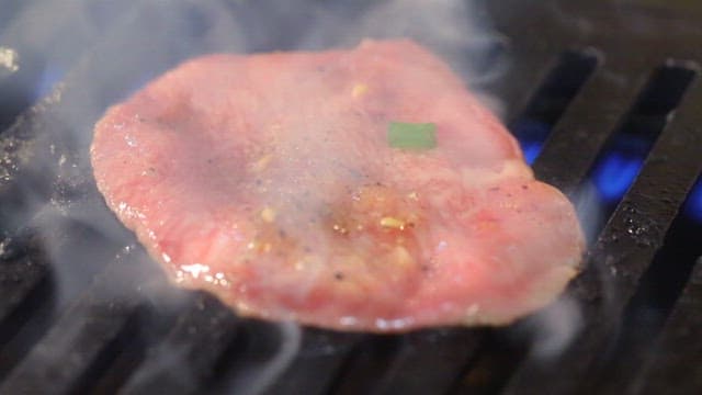 Sizzling meat on a hot grill