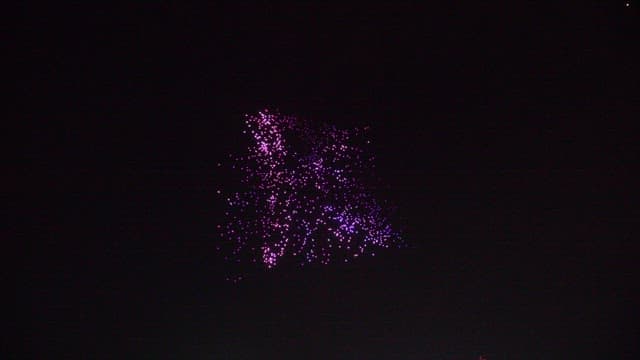 Colorful drone light show in nighttime sky