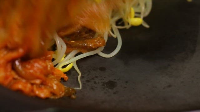 Kimchi and bean sprouts on a hot pan