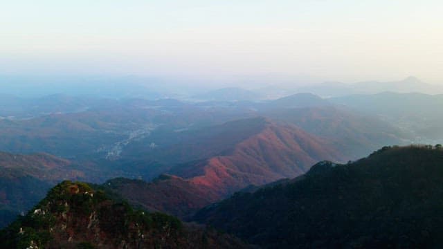 Magnificent mountains and canyons illuminated by sunlight through the fog