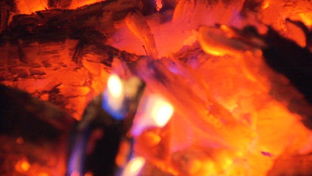 Glowing and burning ember in a cozy fireplace