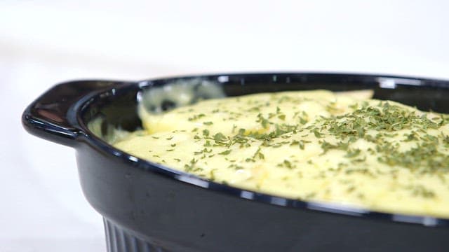 Dish with delicious cheesy baked food