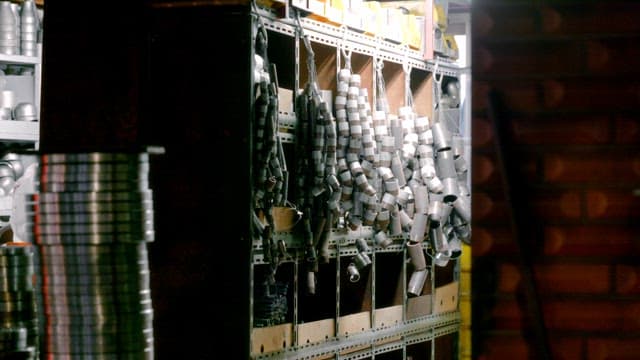 Metal parts organized on shelves in a workshop