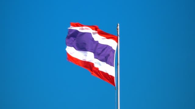 Brightly fluttering Thai national flag on a clear day