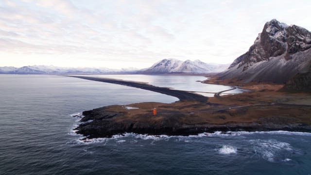 Coastal landscape with snowy mountains