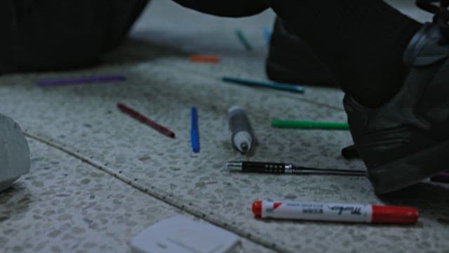 Person Struggling to Loosen the Cable Ties Binding his Hands