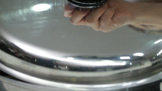 Pot of boiling samgyetang made with abalone being uncovered