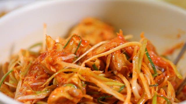 Spicy sea snails salad with green onions and dried monkfish