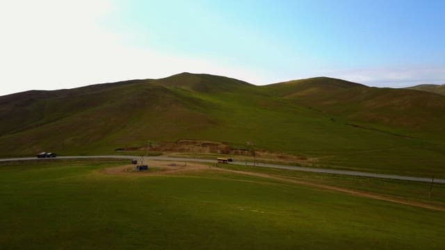 Rolling green hills with a road