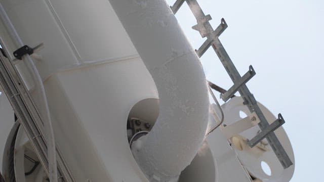 Frosted industrial pipe emitting steam