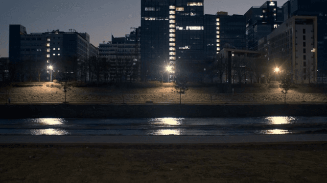 Night view of a city with buildings and river