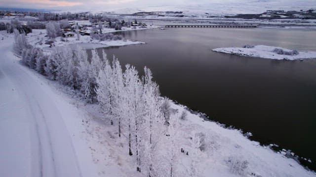 Snow-covered landscape with a serene lake