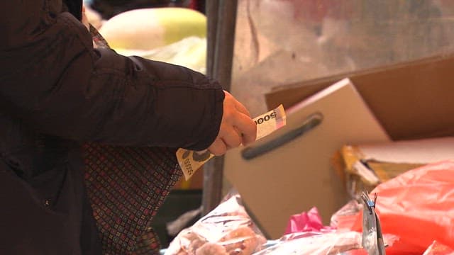 Customer paying at market stall