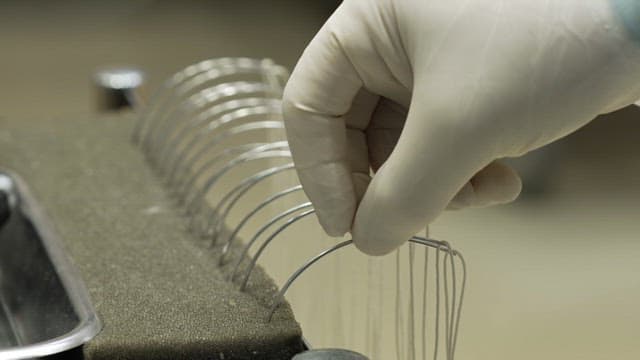 Gloved hand handling surgical wires