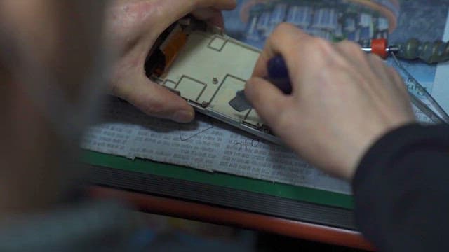 Hands Repairing Electronic Circuit Board