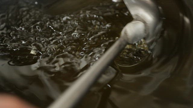 Stirring oil in a pot